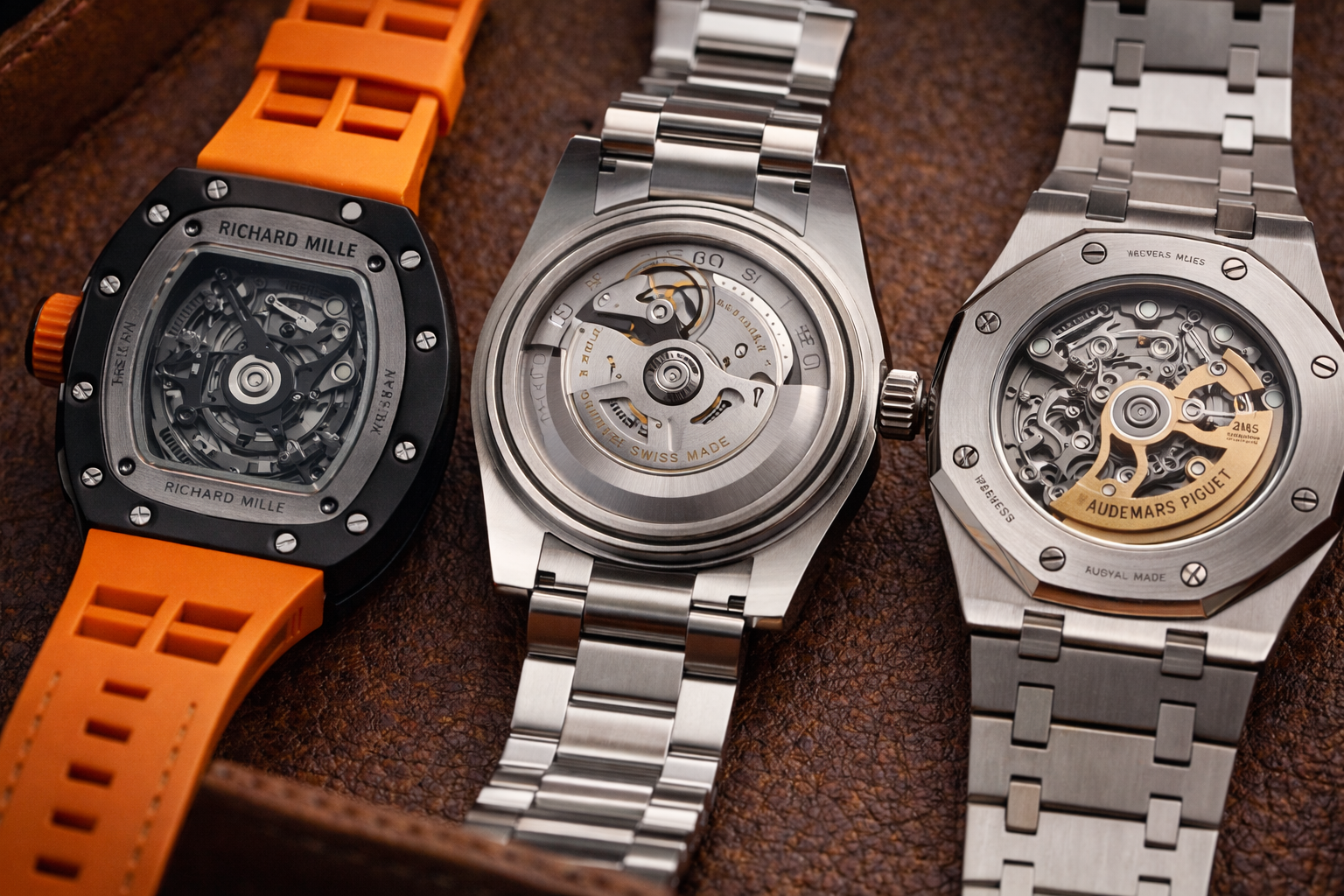 Caseback and movement-style comparison across three luxury-style replica watches